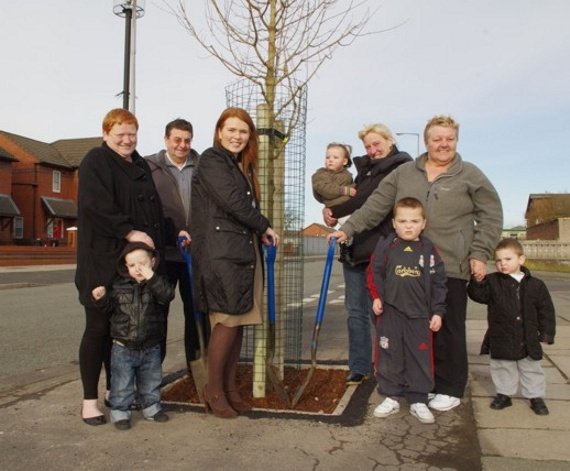 Local community pose with newly planted street tree
